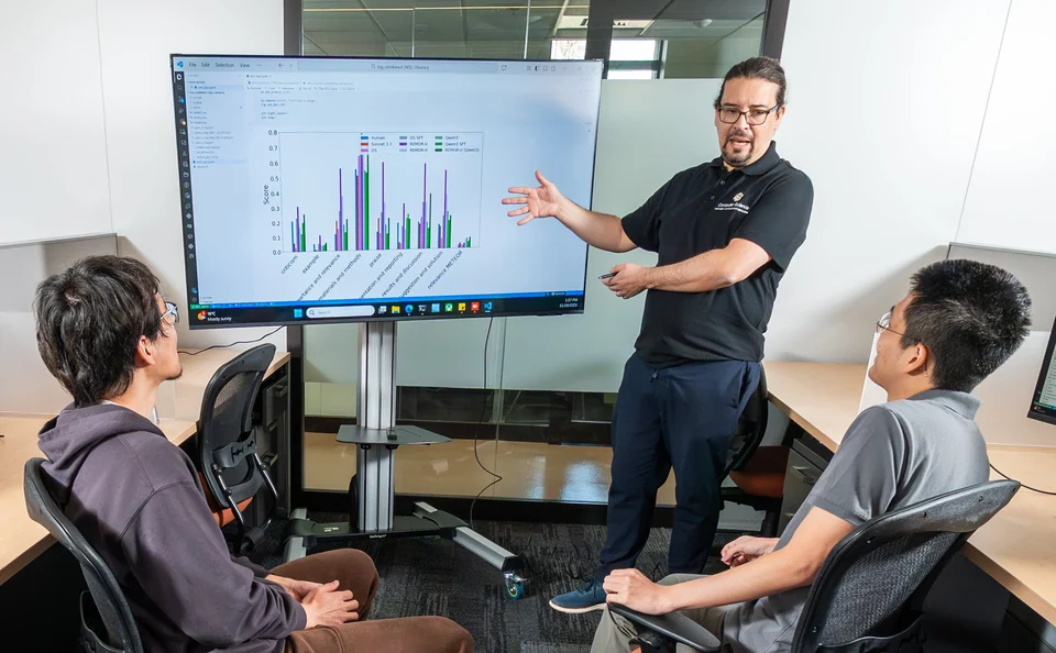 Daniel Acuna discussing research results with lab members at CU Boulder